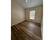 A cozy bedroom with hardwood floors and natural light creates a serene atmosphere at 300 Churchill Dr, Longwood, FL 32779