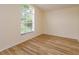Bright bedroom with hardwood flooring and a large window letting in lots of natural light at 300 Churchill Dr, Longwood, FL 32779
