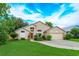 Charming single Gathering home with a well-manicured lawn and a bright red front door at 300 Churchill Dr, Longwood, FL 32779