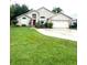 Charming one-story home features a well-manicured lawn and attached two-car garage at 300 Churchill Dr, Longwood, FL 32779