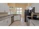 Spacious eat-in kitchen with stainless steel appliances, granite countertops, and large windows at 300 Churchill Dr, Longwood, FL 32779