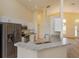 Open concept kitchen with stainless steel appliances, granite countertops, and white cabinets at 300 Churchill Dr, Longwood, FL 32779
