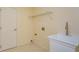 Functional laundry room with a utility sink, storage shelf, and tiled flooring at 300 Churchill Dr, Longwood, FL 32779