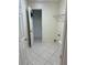 A functional laundry room with tile floors, storage shelves, and washer hookups for convenience at 300 Churchill Dr, Longwood, FL 32779