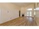 Living room features a ceiling fan, wood laminate flooring, fireplace, and backyard access at 300 Churchill Dr, Longwood, FL 32779