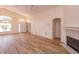 Bright living room featuring wood floors, neutral paint, fireplace, arched doorways, and high ceilings at 300 Churchill Dr, Longwood, FL 32779