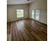 Spacious living room features wood-look floors, window and glass doors at 300 Churchill Dr, Longwood, FL 32779