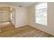 Inviting living room with a large arched window and wood laminate flooring at 300 Churchill Dr, Longwood, FL 32779