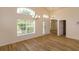 Living room featuring neutral walls, wood laminate flooring, and lots of natural light at 300 Churchill Dr, Longwood, FL 32779