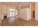 Open living room with a fireplace, tile accents, and wood laminate flooring at 300 Churchill Dr, Longwood, FL 32779