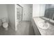Well-lit bathroom with granite countertops, a shower, and tile flooring at 3087 Sunset Hills Rd, Winter Haven, FL 33881