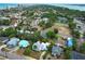 An aerial view of a coastal neighborhood with palm trees, various home styles, and access to the beach at 330 Phoenix Ave, Daytona Beach, FL 32118