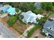Aerial view of a charming home with light blue accents and a unique garden landscape, surrounded by lush greenery at 330 Phoenix Ave, Daytona Beach, FL 32118