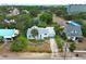 Aerial view of a white house with blue shutters, blue trim and a palm tree in the front yard at 330 Phoenix Ave, Daytona Beach, FL 32118