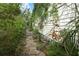 Backyard features a stone pathway, plants and a white house at 330 Phoenix Ave, Daytona Beach, FL 32118