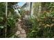 Backyard features an air conditioning unit surrounded by landscaping with a stepping stone pathway at 330 Phoenix Ave, Daytona Beach, FL 32118