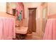 Pink bathroom features a sink, mirror, toilet, and shower at 330 Phoenix Ave, Daytona Beach, FL 32118