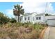 Charming exterior showcasing a two-story home with a quaint front yard and lush landscaping at 330 Phoenix Ave, Daytona Beach, FL 32118