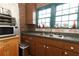 Functional kitchen includes a double sink, window, and cabinetry for ample storage and functionality at 330 Phoenix Ave, Daytona Beach, FL 32118