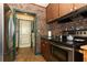 Kitchen featuring brick walls, and a stainless-steel oven with a refrigerator nearby at 330 Phoenix Ave, Daytona Beach, FL 32118