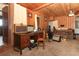 Living room with wooden walls, brown sofa, guitars, and a wooden desk with audio amplifiers at 330 Phoenix Ave, Daytona Beach, FL 32118
