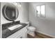 Modern bathroom with stylish vanity, granite countertop, decorative mirror and natural light at 3321 Crimson Ln, Deltona, FL 32738