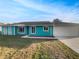 Charming single-story home with a well-manicured lawn and a two-car garage at 3321 Crimson Ln, Deltona, FL 32738