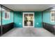 Covered patio with turquoise siding and sliding glass door leading to the interior at 3321 Crimson Ln, Deltona, FL 32738
