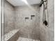 Updated tiled shower featuring corner bench, niches, and modern fixtures at 3321 Crimson Ln, Deltona, FL 32738