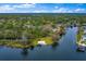 Aerial view showcasing waterfront homes and lush greenery by a body of water, creating a serene landscape at 334 N Shadowbay Blvd, Longwood, FL 32779