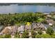 Breathtaking aerial view of a lakefront home nestled among lush trees at 334 N Shadowbay Blvd, Longwood, FL 32779