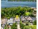Stunning aerial view of lakefront home with lush green landscaping and solar panels on roof at 334 N Shadowbay Blvd, Longwood, FL 32779