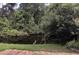 Lush backyard view featuring a pond and a heron, surrounded by dense trees and greenery at 334 N Shadowbay Blvd, Longwood, FL 32779