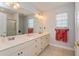 Bright bathroom features a dual sink vanity with ample counter space and a large mirror, great for getting ready at 334 N Shadowbay Blvd, Longwood, FL 32779