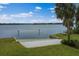 Sandy beach access with lush grass, a picnic bench and a calm lake view at 334 N Shadowbay Blvd, Longwood, FL 32779