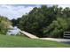 Scenic boat ramp surrounded by green grass and trees, leading to calm waters perfect for boating at 334 N Shadowbay Blvd, Longwood, FL 32779