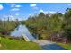 Community boat ramp along a canal with lush vegetation and mature trees on a sunny day at 334 N Shadowbay Blvd, Longwood, FL 32779