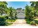 Charming two-story home featuring mature landscaping, a palm tree and an attached two car garage at 334 N Shadowbay Blvd, Longwood, FL 32779