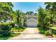 Traditional two-story gray house with mature trees and landscaping plus a two-car garage at 334 N Shadowbay Blvd, Longwood, FL 32779