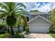 Charming home featuring a well-manicured lawn, tropical palm trees and a two-car garage at 334 N Shadowbay Blvd, Longwood, FL 32779