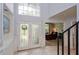 Elegant foyer with decorative glass doors, tile flooring, and soaring ceilings at 334 N Shadowbay Blvd, Longwood, FL 32779