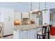 Charming kitchen with white cabinetry, granite countertops, and stylish bar seating with pendant lights at 334 N Shadowbay Blvd, Longwood, FL 32779