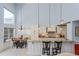 Elegant kitchen with granite countertops, white cabinets, and high ceilings, perfect for entertaining at 334 N Shadowbay Blvd, Longwood, FL 32779