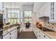 Open kitchen with granite countertops, stainless appliances, white cabinets and adjacent dining space at 334 N Shadowbay Blvd, Longwood, FL 32779