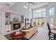 Bright living room with a fireplace, vaulted ceiling and large windows at 334 N Shadowbay Blvd, Longwood, FL 32779