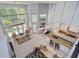 Open-concept living room featuring soaring ceilings, expansive windows, and a seamless flow to the kitchen at 334 N Shadowbay Blvd, Longwood, FL 32779