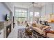 Bright living room with a fireplace, vaulted ceiling and large windows at 334 N Shadowbay Blvd, Longwood, FL 32779