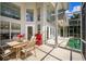 Spacious patio with tall windows and seating area next to an in-ground pool at 334 N Shadowbay Blvd, Longwood, FL 32779