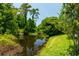 Scenic pond view showcasing the tranquil backyard setting with abundant trees at 334 N Shadowbay Blvd, Longwood, FL 32779