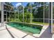 An in-ground pool is surrounded by mature landscaping and a screened-in enclosure at 334 N Shadowbay Blvd, Longwood, FL 32779